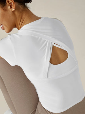 
            
                Load image into Gallery viewer, Beyond Yoga - Featherweight Peekaboo Cropped Tee - Cloud White - Pilates Plus La Jolla - OHEY Boutique
            
        